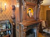 a fireplace in the middle of a living room with a clock on it