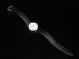 an image of a close up of a wrist watch on a black surface