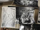 several black and white photos of people on a table in a room