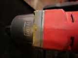 a close up of a drill with a red handle