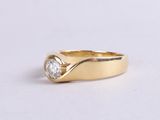an image of a gold ring with a diamond