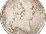 Gros plan sur une pièce de monnaie portant le visage d'un homme