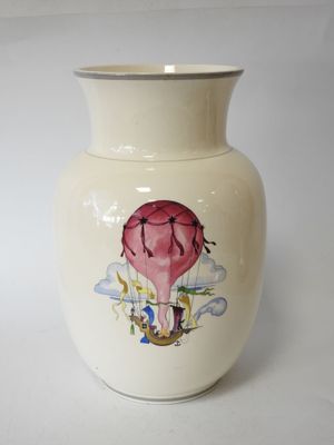 a white vase with a picture of a hot air balloon on it