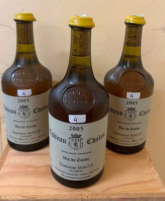 three bottles of wine sitting on top of a wooden table