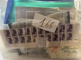a clear container with stamps and a note in it