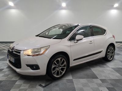 a white citrole parked on a checkered floor in a garage