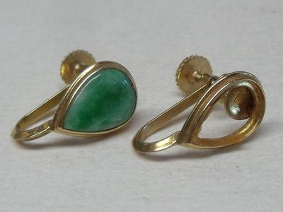 two pairs of gold and green stone earrings on a white surface
