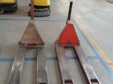 three forklifts sitting on the floor in a warehouse