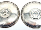 pair of silver plated earrings with spiral designs on them