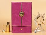 purple and gold jewelry box with a sunburst on top of it