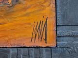 a painting on the wall of a building that is painted orange