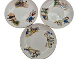 three plates with cartoon characters on them on a white surface