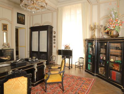 an image of a living room with a desk and a chair
