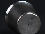 a close up of a metal object on a black surface