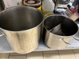 pots and pans on a shelf in a kitchen filled with food