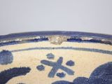a blue and white bowl with a bird design on it