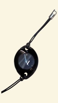 a picture of a black clock on a black cord