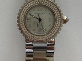 an image of a wrist watch with a diamond bezeled bezeled dial