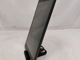 a tablet computer sitting on top of a stand on a white surface