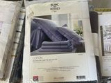 a pile of bedding and sheets on a bed