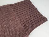 brown knitted scarf on a white table with a white background