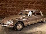 a brown car that is parked in front of a brick wall