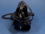 a small black purse with a chain around it