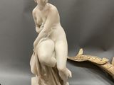a statue of a woman sitting on top of a table
