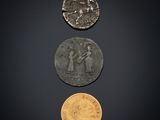 three different types of coins on a black background
