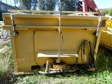 a yellow dump truck that is sitting in the grass
