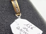 an image of a tag with a pink stone on it