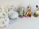 several figurines of different sizes and shapes are lined up on a white surface