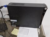 a black computer sitting on top of a desk next to a keyboard and mouse