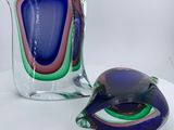 two glass vases that are sitting on a table