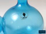 two blue vases sitting next to each other on a table