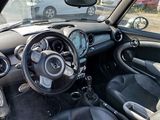 a small black car with a steering wheel and dashboard