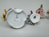 three porcelain figurines that are sitting on a table