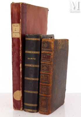 two old books sitting on top of each other on a table