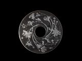 a close up of a coin with a flower design on it