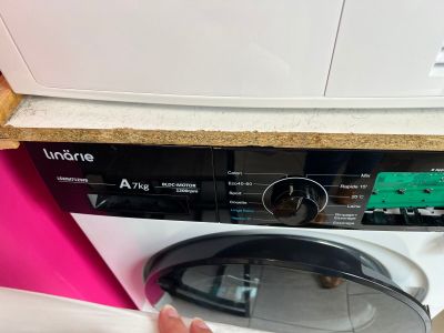 a person that is putting something in a washing machine