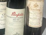 three bottles of wine sitting on a table next to each other