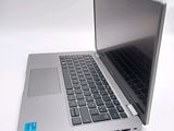 a silver laptop computer sitting on top of a white table