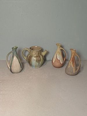 five different types of vases sitting on a table