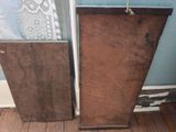 two pieces of wood sitting on the floor next to each other