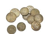 some coins are sitting on top of each other on a white surface