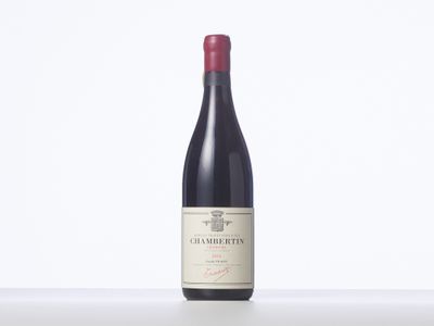 a bottle of red wine sitting on top of a table