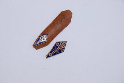 two pieces of leather with blue and white designs on them