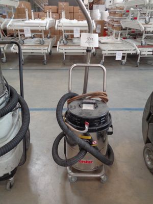 two vacuums that are sitting in a room