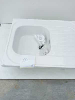 a white sink with a white faucet and a white faucet