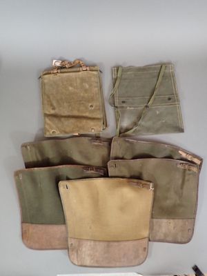 many different bags hanging on the wall next to each other